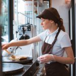 A restaurant staff member prepares a food order in a QSR.
